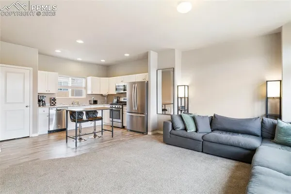 a living room with furniture and kitchen view