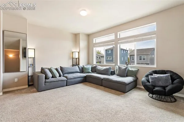 a living room with furniture and a large window