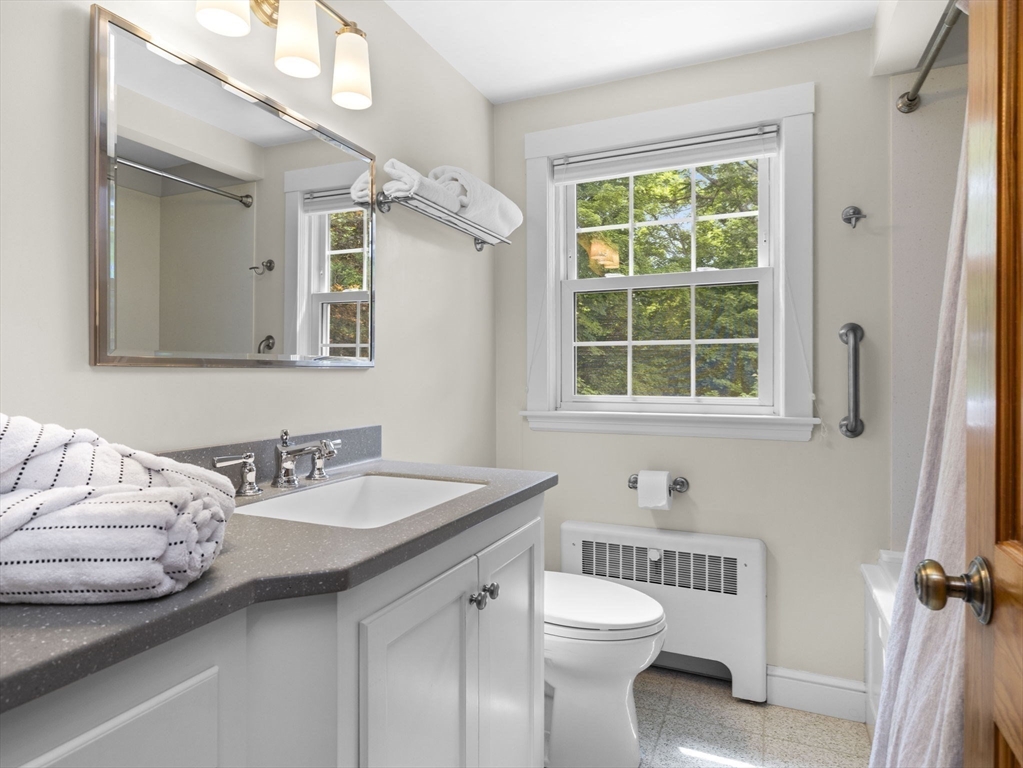 35 Winter Street Framingham, MA 01702 - Photo 17 of 22 a bathroom with a sink a toilet and a mirror