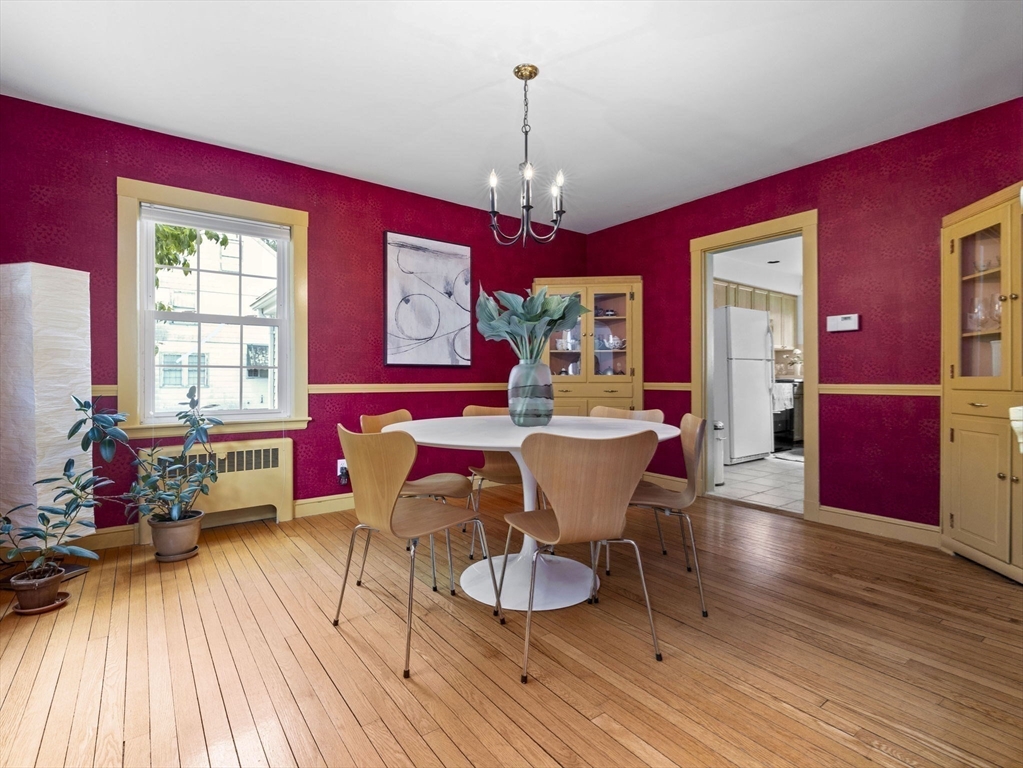 35 Winter Street Framingham, MA 01702 - Photo 8 of 22 a dining room with wooden floor a chandelier a wooden table and chairs