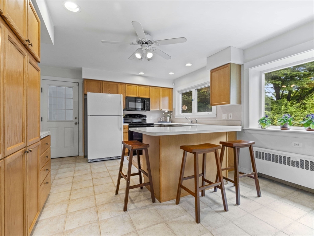 35 Winter Street Framingham, MA 01702 - Photo 9 of 22 a kitchen with stainless steel appliances kitchen island granite countertop a refrigerator and microwave