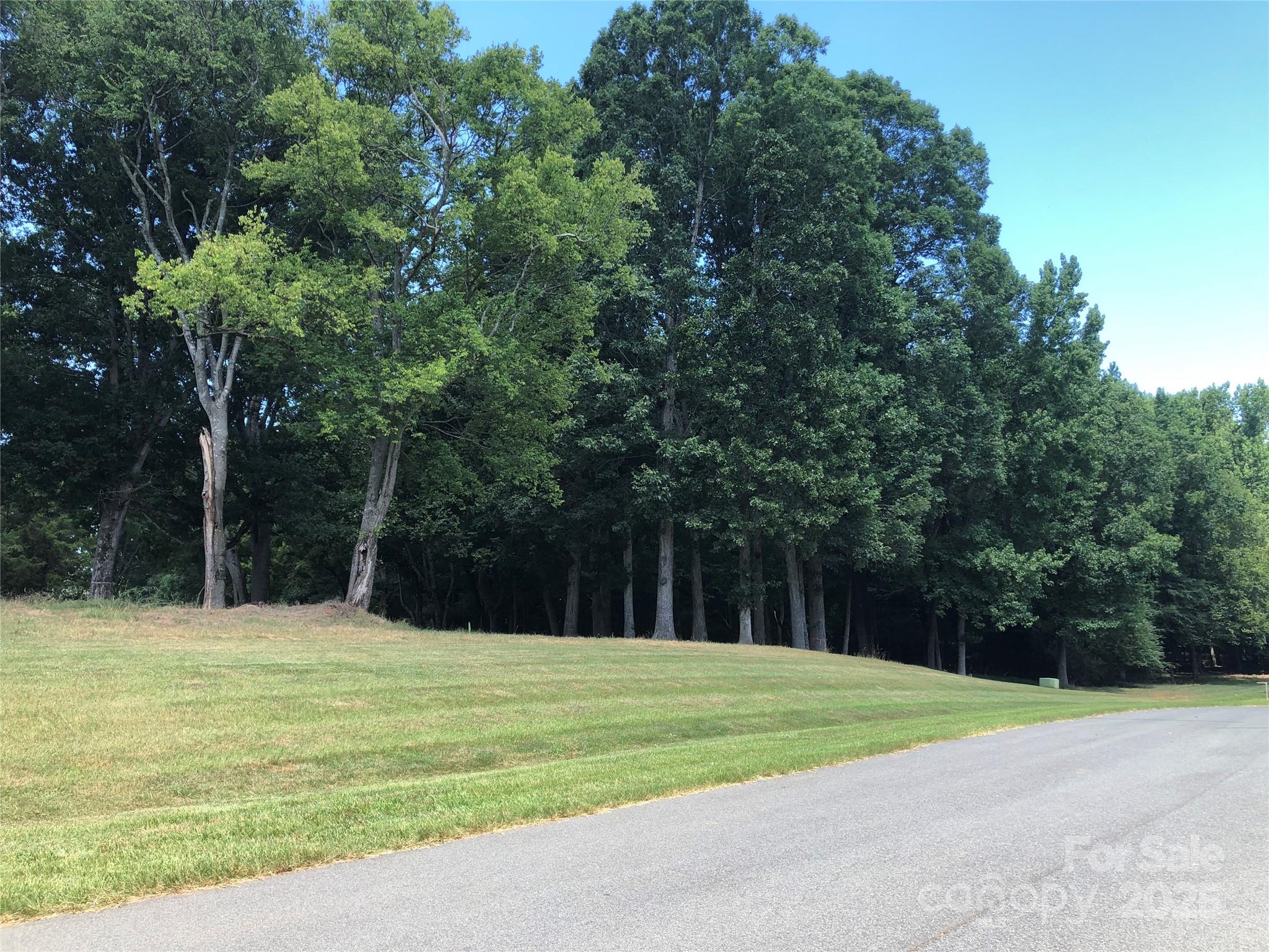 6639 Joli Cheval Lane, Unit 4 Mint Hill, NC 28227 - Photo 2 of 18 a swimming pool with outdoor seating and yard