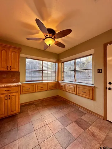 a large kitchen with stainless steel appliances granite countertop a stove a sink and a refrigerator