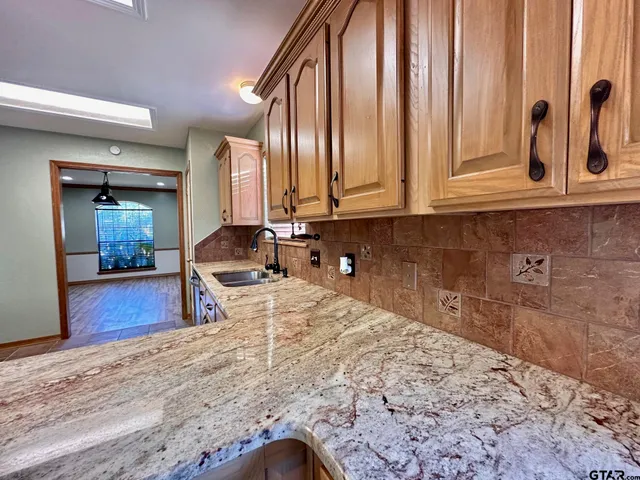 a view of a bedroom with wooden floor and furniture