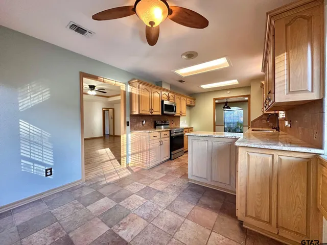a kitchen with cabinets and window