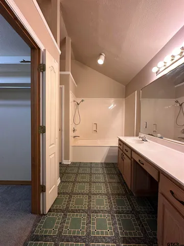a bathroom with a glass door shower a sink and a mirror