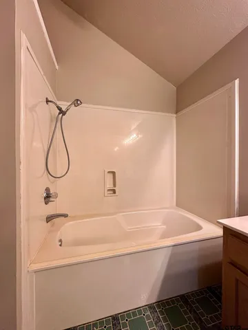 a bathroom with a bathtub and shower