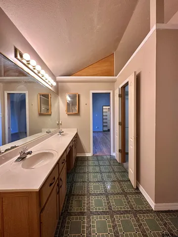 a spacious bathroom with a double vanity sink and a mirror