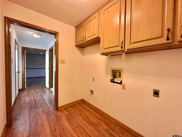 a view of a closet area with wooden floor