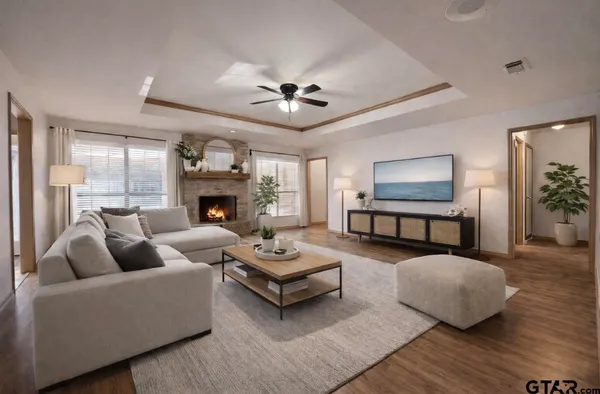 a living room with couches a fireplace and a chandelier