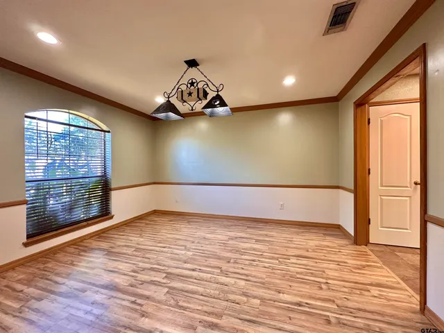 a view of a livingroom with wooden floor and a window