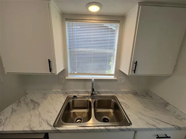 a kitchen that has a sink and a stove