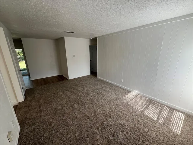 a view of an empty room and closet area