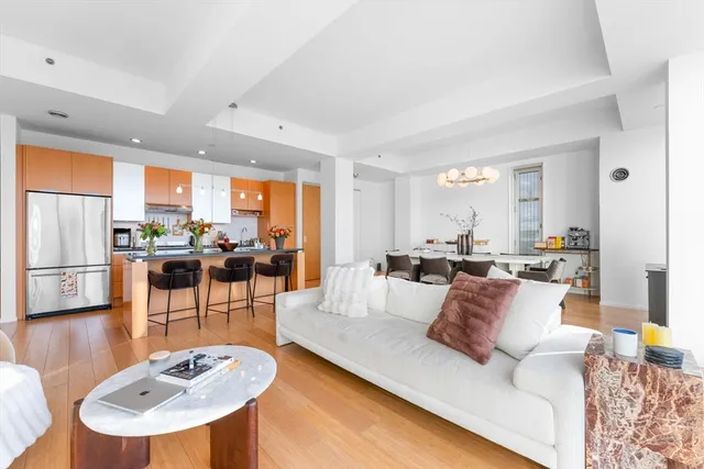 a living room with furniture a dining table and chairs