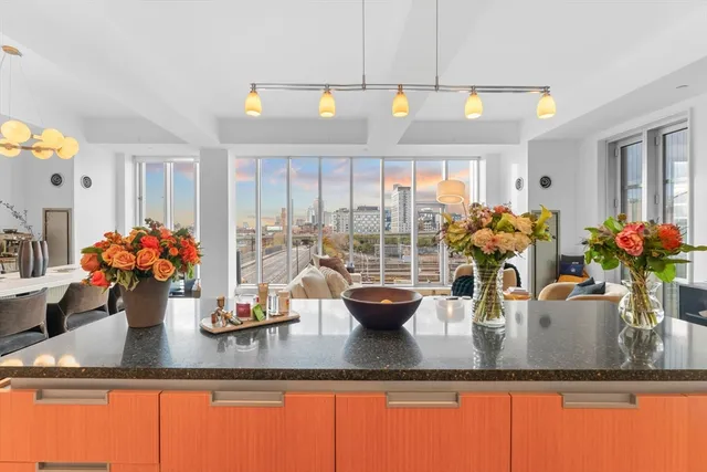 a view of a dining room with furniture a chandelier and wooden floor