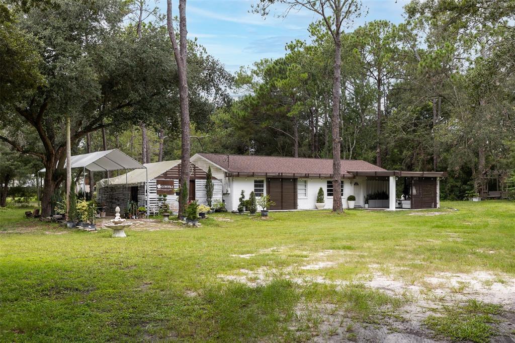 6755 Old Pasco Road Wesley Chapel, FL 33544 - Photo 1 of 1 a front view of a house with a yard