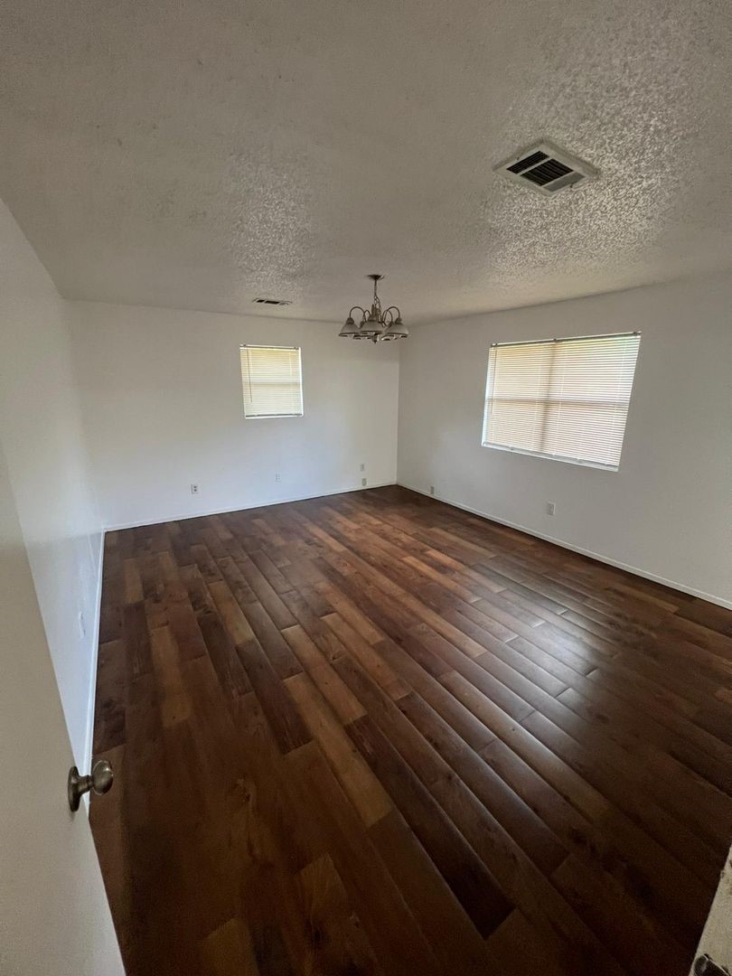 3058 Old Colony Road Huntsville, TX 77320 - Photo 5 of 14 wooden floor in an empty room