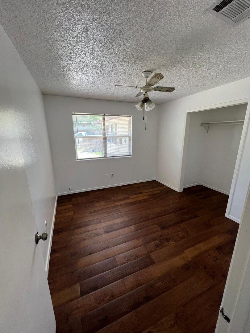 3058 Old Colony Road Huntsville, TX 77320 - Photo 6 of 14 wooden floor in an empty room