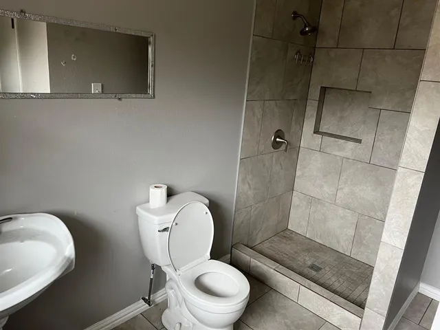a white toilet sitting next to a bathroom sink