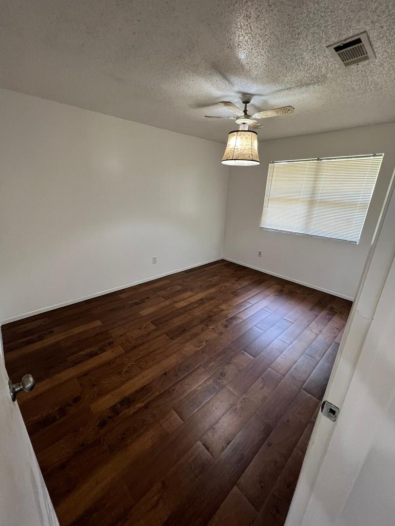 3058 Old Colony Road Huntsville, TX 77320 - Photo 10 of 14 wooden floor in an empty room