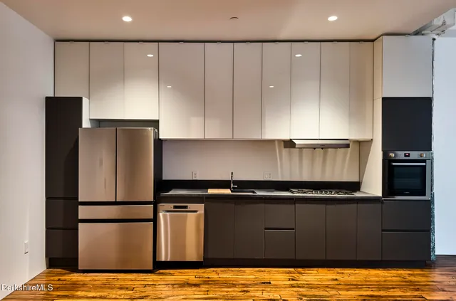 a kitchen with a refrigerator and a stove