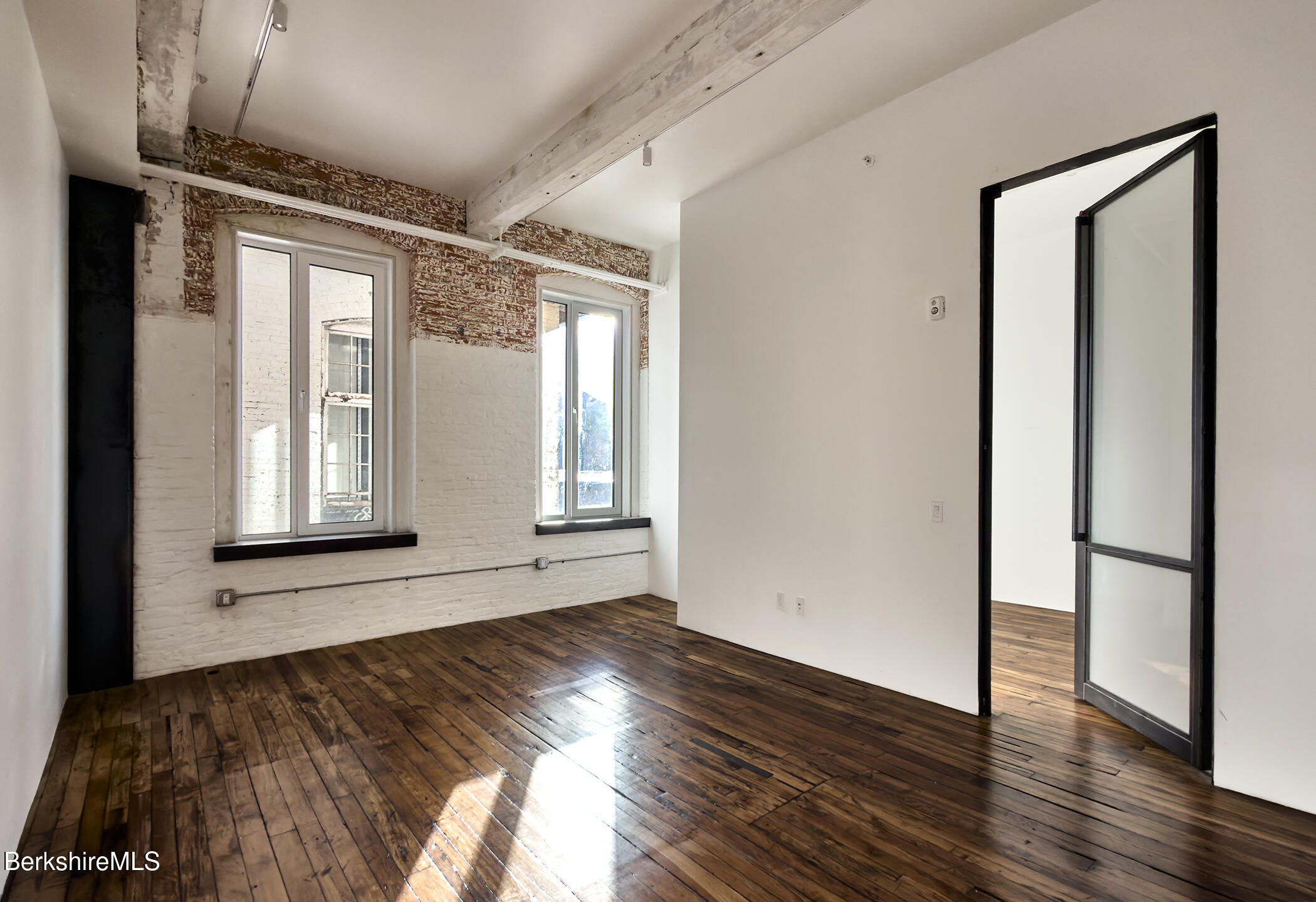 520 State Road, Unit 206 North Adams, MA 01247 - Photo 9 of 16 a view of an empty room with wooden floor and a window