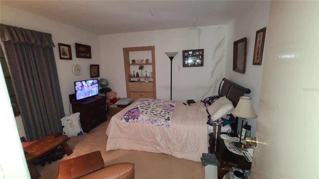 501 Hermits Trail Altamonte Springs, FL 32701 - Photo 34 of 61 a bedroom with a bed and dresser