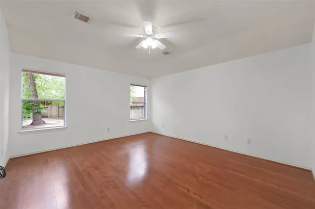 wooden floor in an empty room with a window
