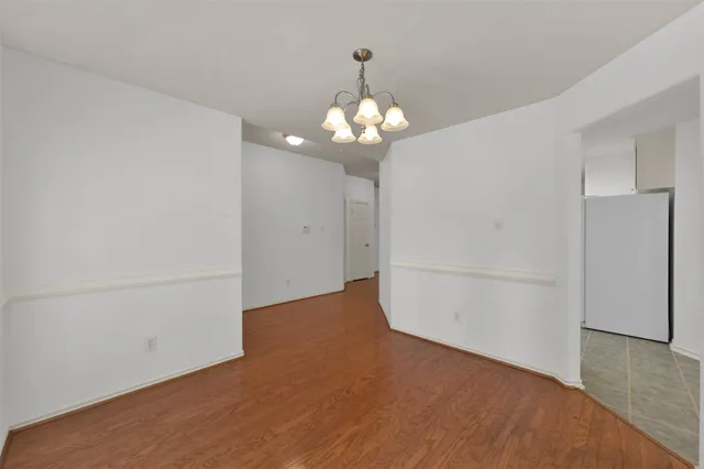 a view of a chandelier fan and wooden floor