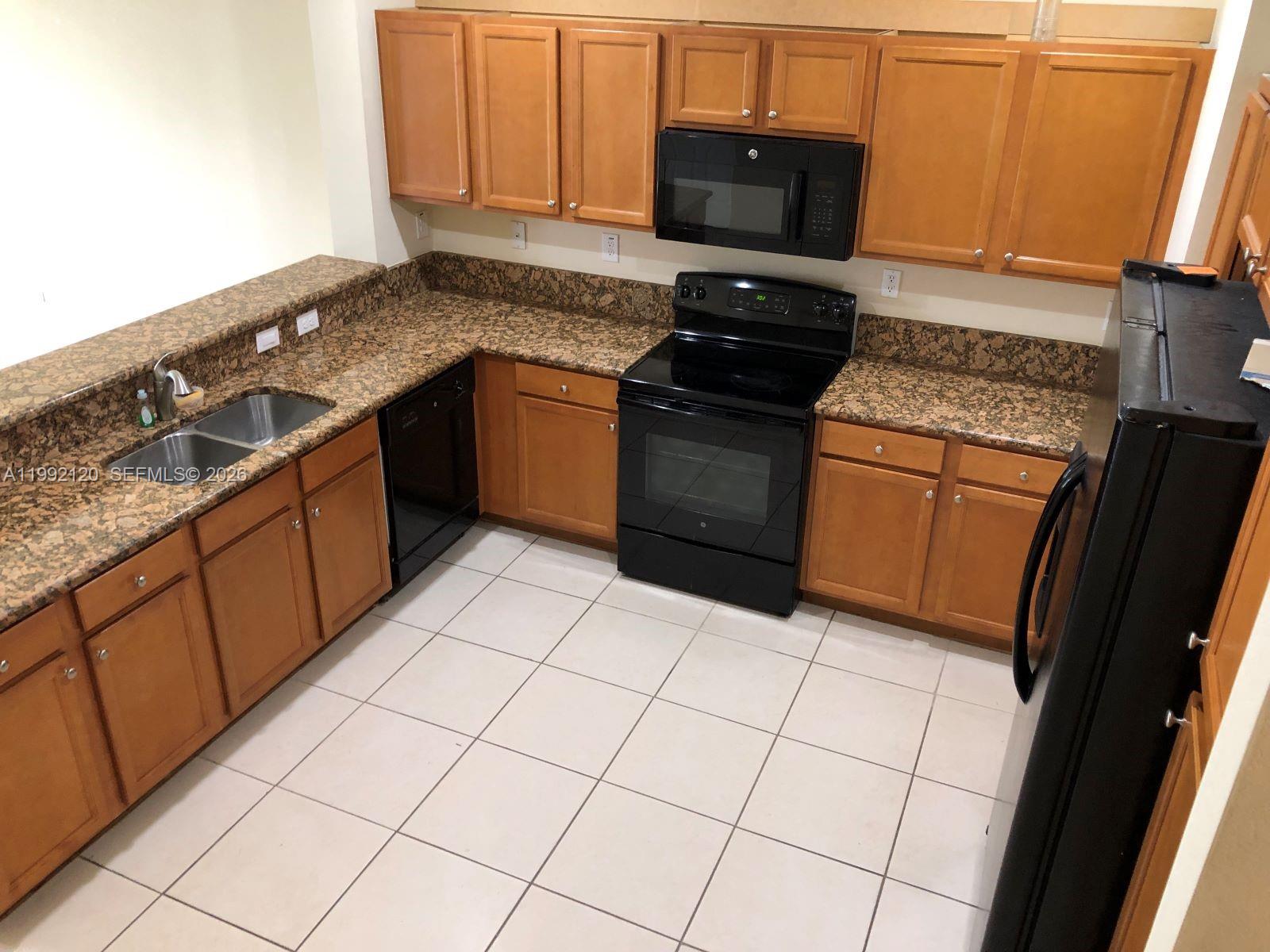 17000 Southwest 90th Terrace Miami, FL 33196 - Photo 3 of 56 a kitchen with stainless steel appliances granite countertop a sink stove and cabinets