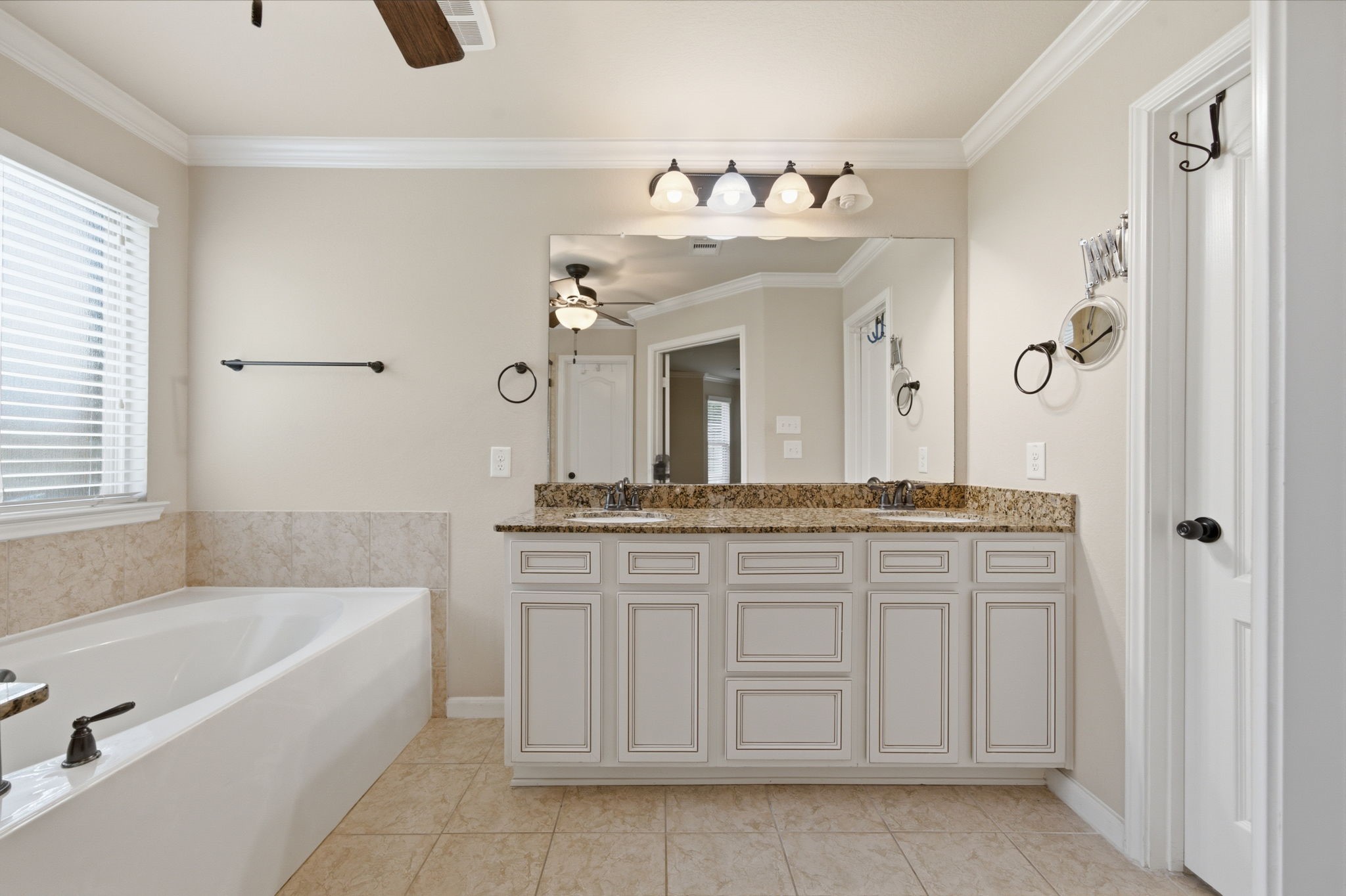 7611 Willow School Drive Spring, TX 77389 - Photo 15 of 23 a bathroom with a tub sink and mirror