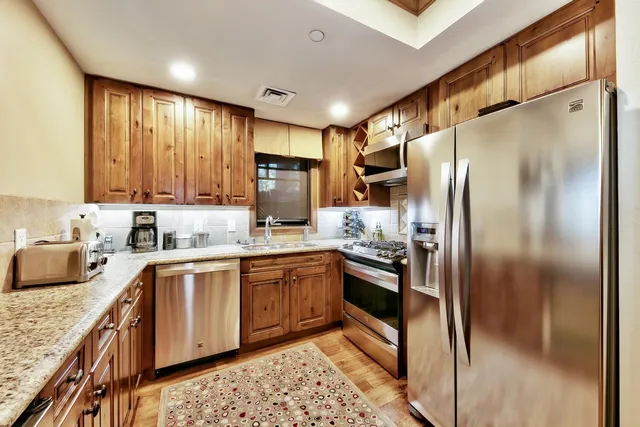 a view of a dining room with furniture a chandelier and wooden floor