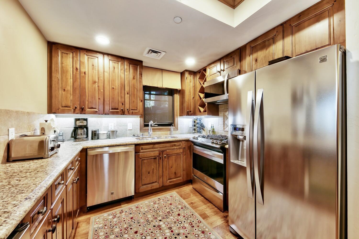 6750 North Lake Boulevard, Unit 13F Tahoe Vista, CA 96148 - Photo 14 of 20 a kitchen with stainless steel appliances granite countertop a refrigerator a stove and a sink
