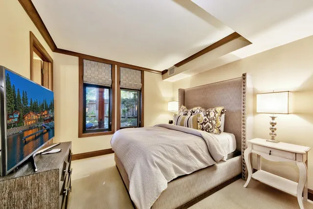 a bedroom with a large bed and a flat screen tv