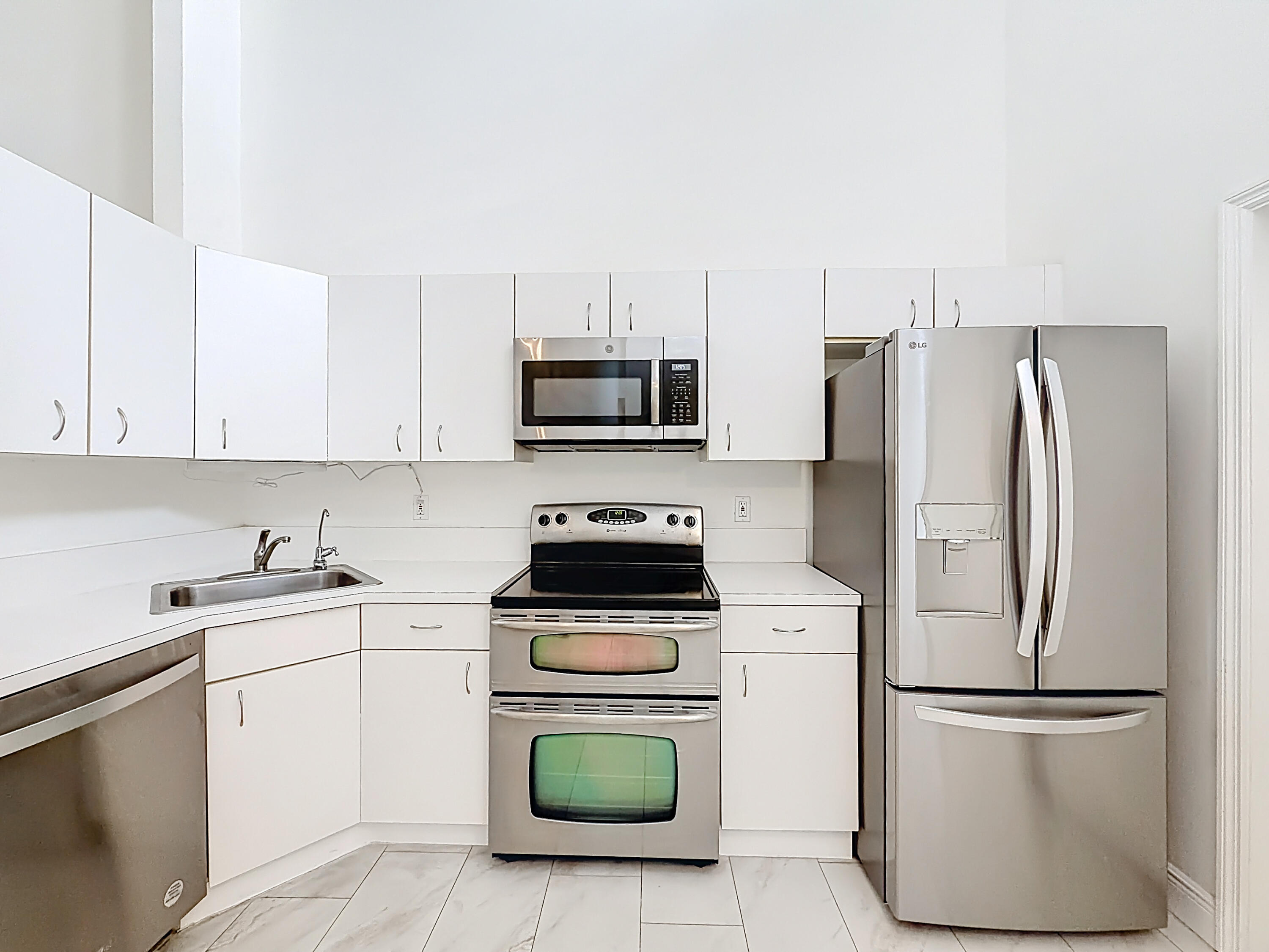 10954 Lakemore Lane Boca Raton, FL 33498 - Photo 11 of 61 a kitchen with a refrigerator sink and white stove