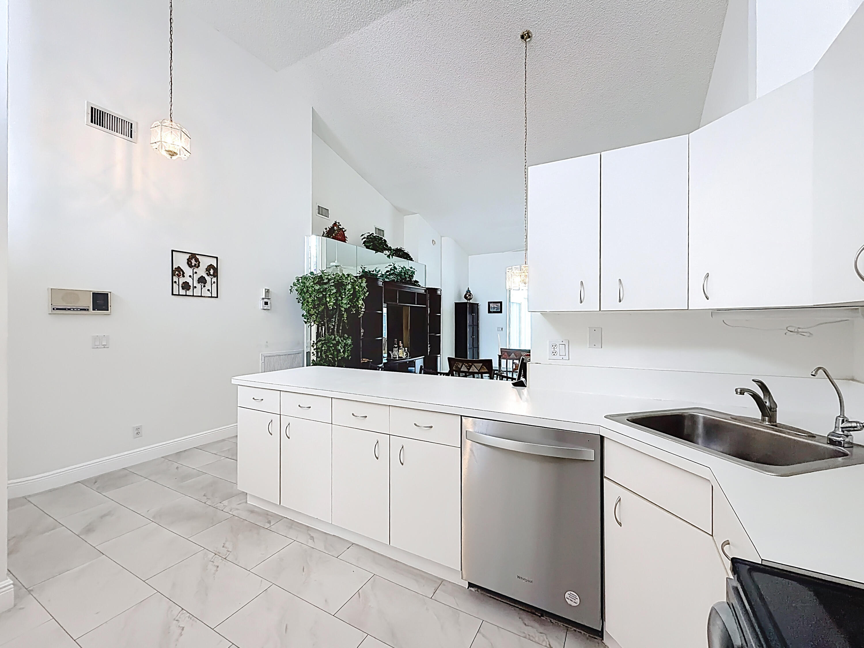 10954 Lakemore Lane Boca Raton, FL 33498 - Photo 13 of 61 a kitchen with white cabinets and sink
