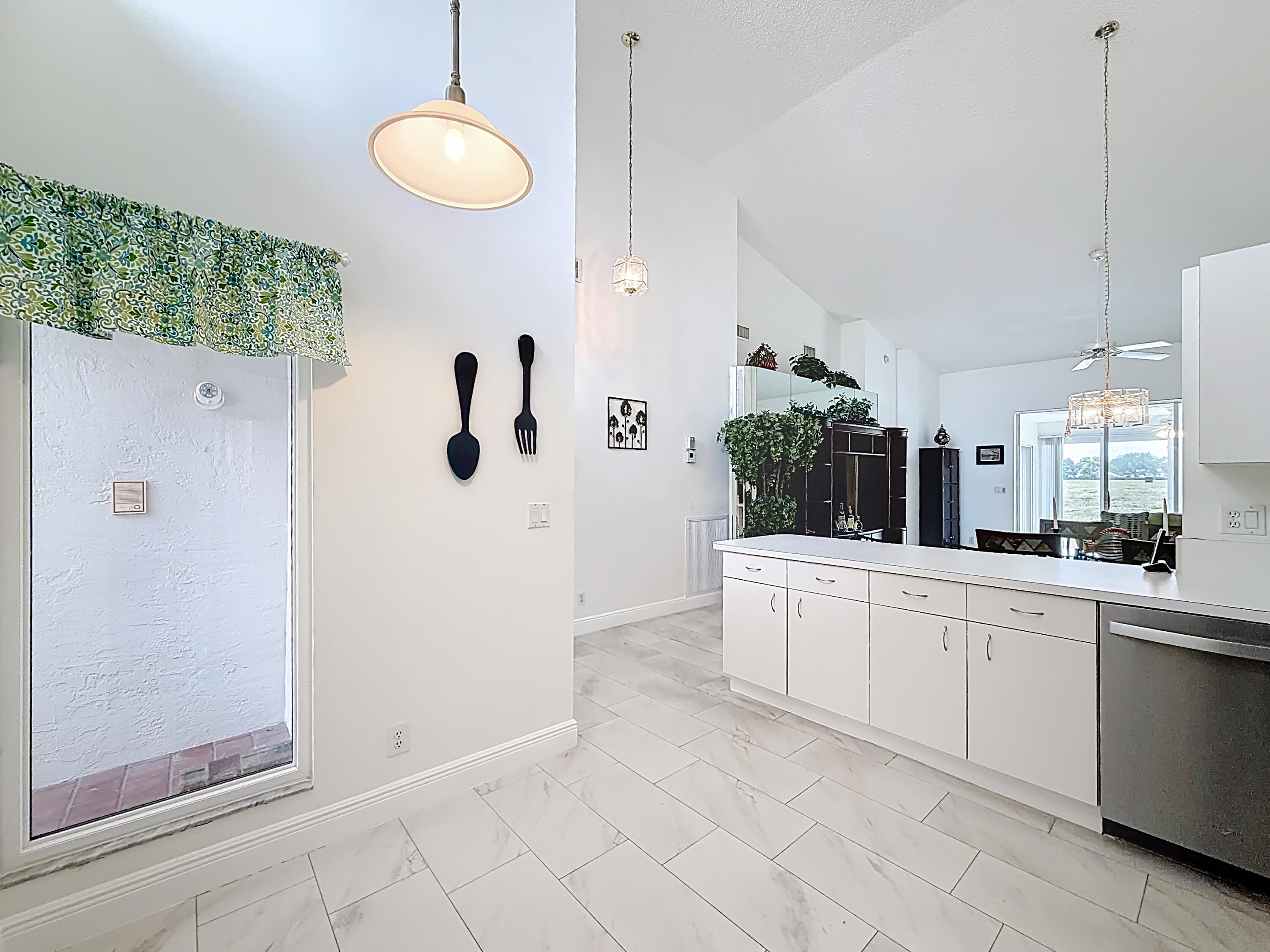 10954 Lakemore Lane Boca Raton, FL 33498 - Photo 14 of 61 a large white kitchen with a sink and dishwasher a refrigerator with white cabinets