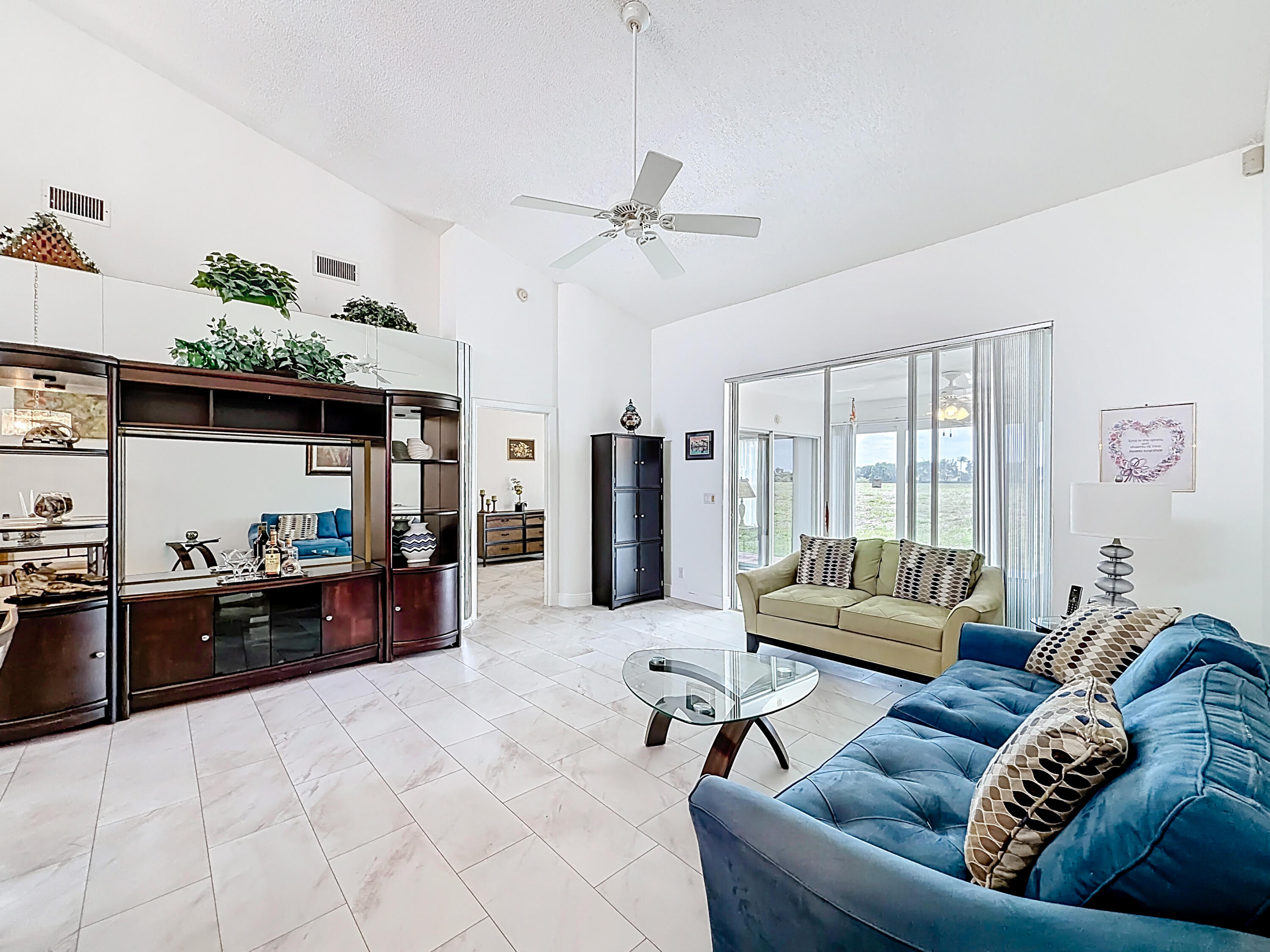 10954 Lakemore Lane Boca Raton, FL 33498 - Photo 19 of 61 a living room with furniture and a flat screen tv