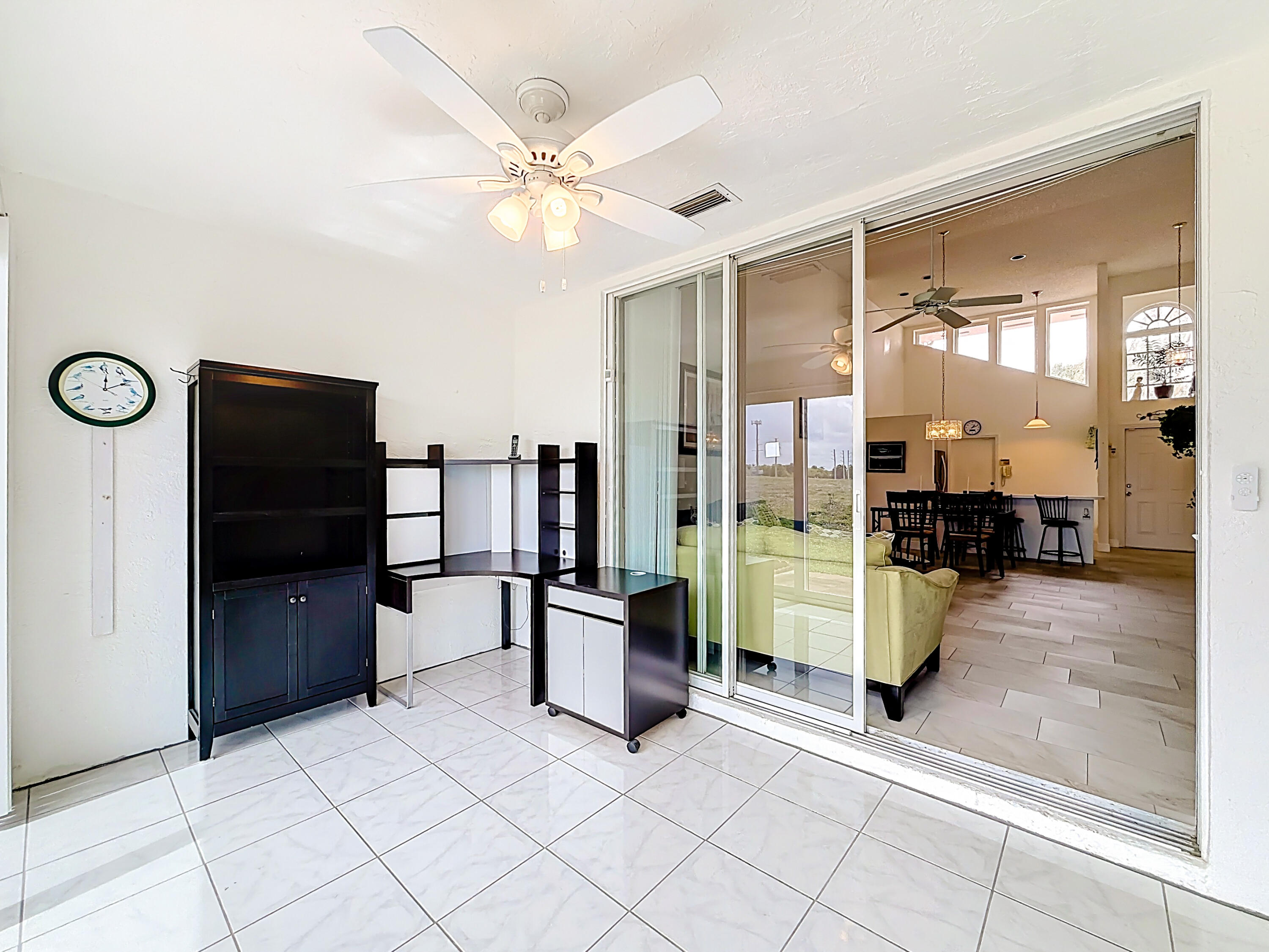 10954 Lakemore Lane Boca Raton, FL 33498 - Photo 26 of 61 a living room with furniture a large window and stainless steel appliances