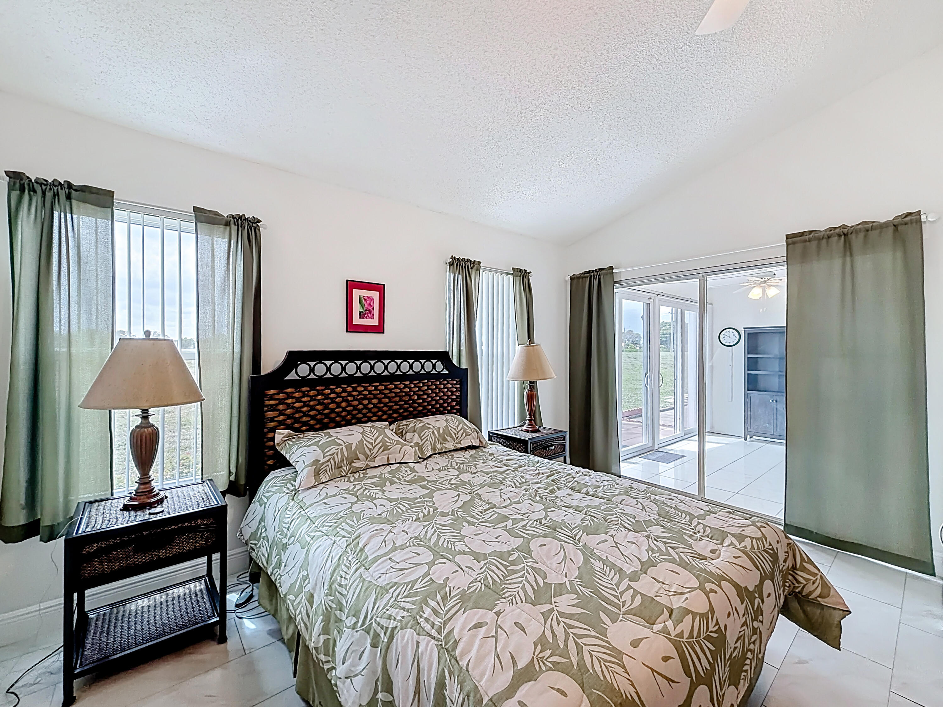 10954 Lakemore Lane Boca Raton, FL 33498 - Photo 30 of 61 a bedroom with a bed and a lamp