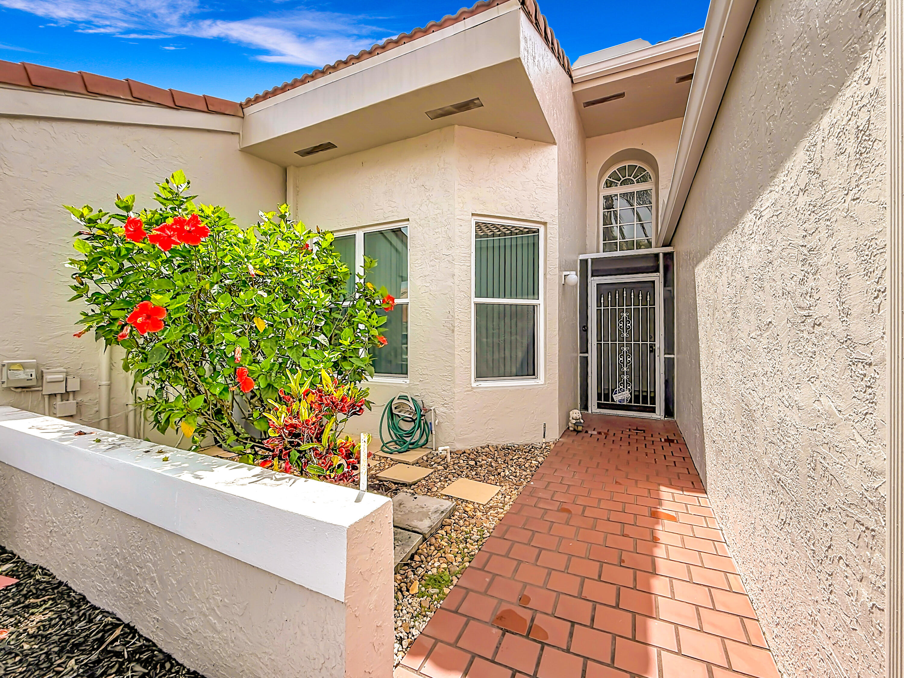 10954 Lakemore Lane Boca Raton, FL 33498 - Photo 3 of 61 a front view of a house with plants