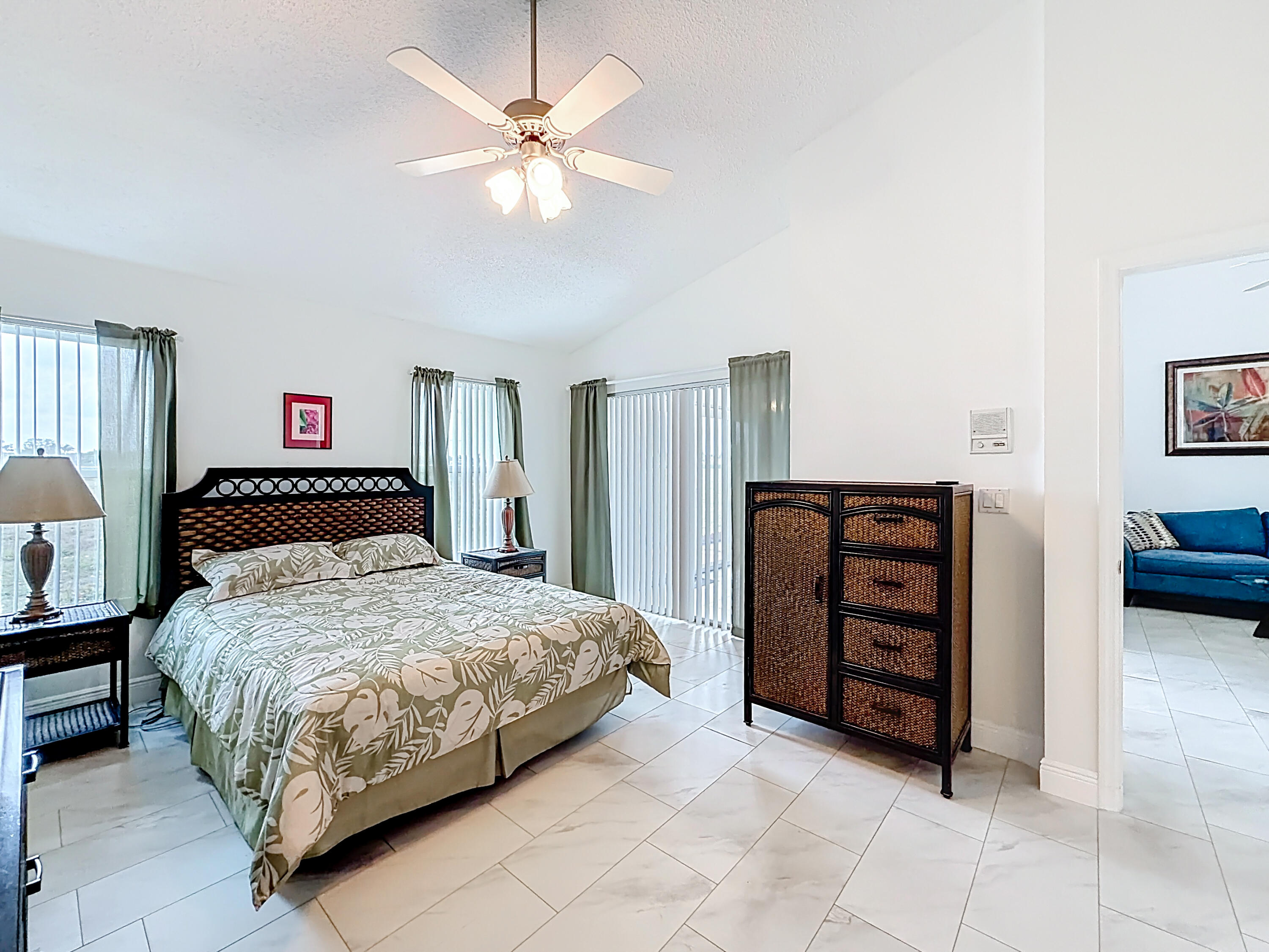 10954 Lakemore Lane Boca Raton, FL 33498 - Photo 32 of 61 a bedroom with a bed and a chandelier