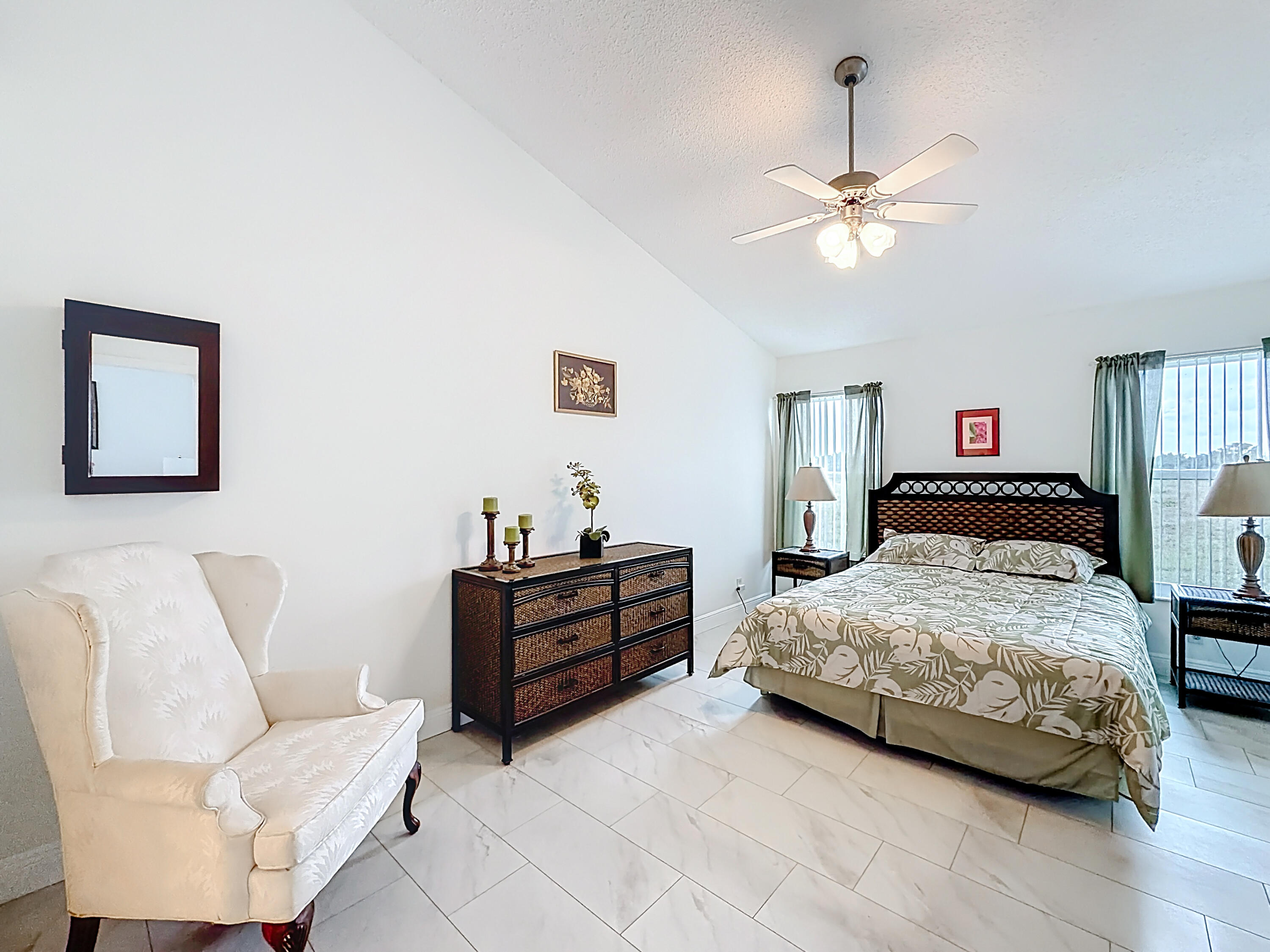 10954 Lakemore Lane Boca Raton, FL 33498 - Photo 33 of 61 a bedroom with a bed and a chandelier