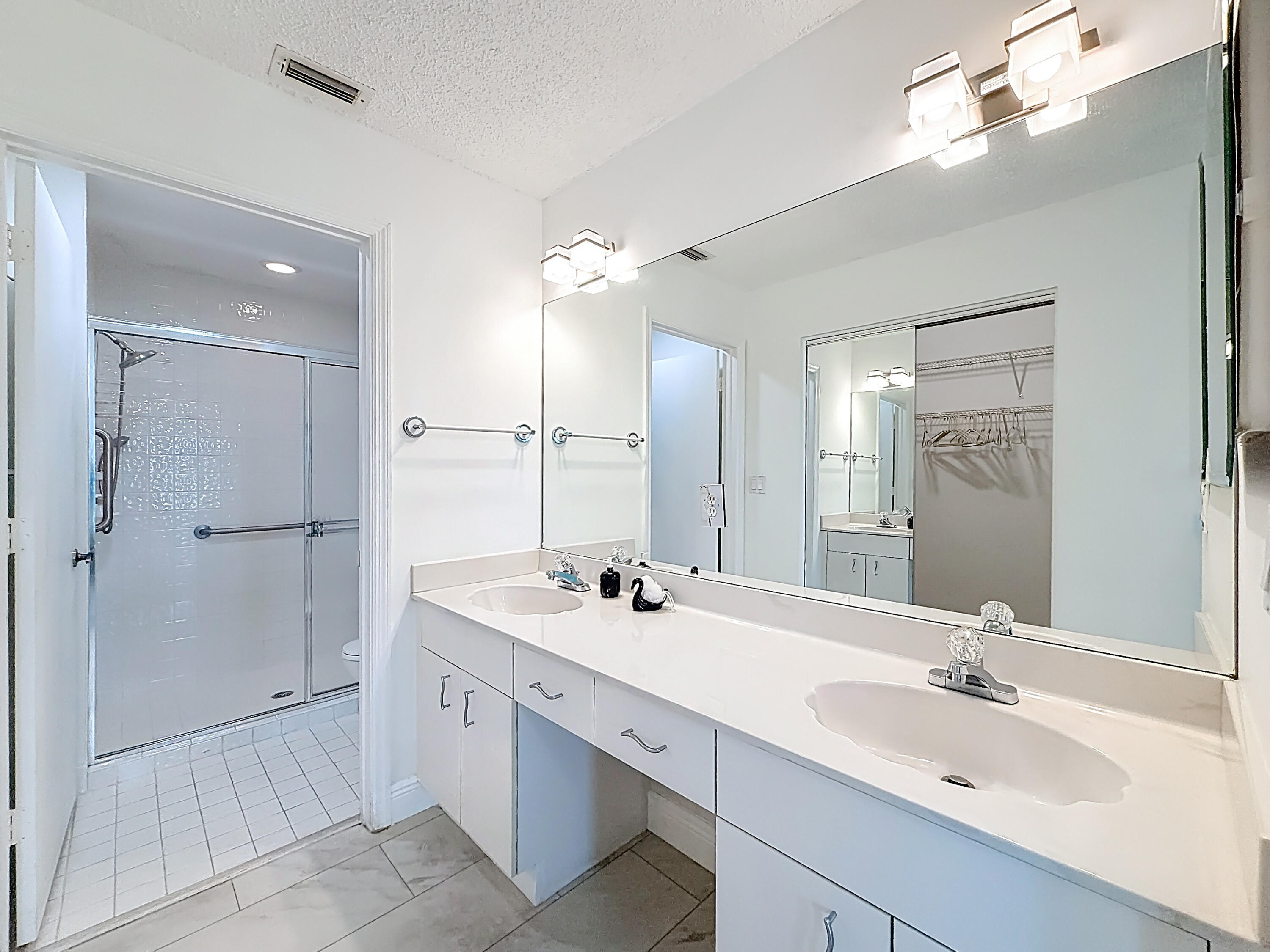 10954 Lakemore Lane Boca Raton, FL 33498 - Photo 42 of 61 a bathroom with a double vanity sink mirror and double