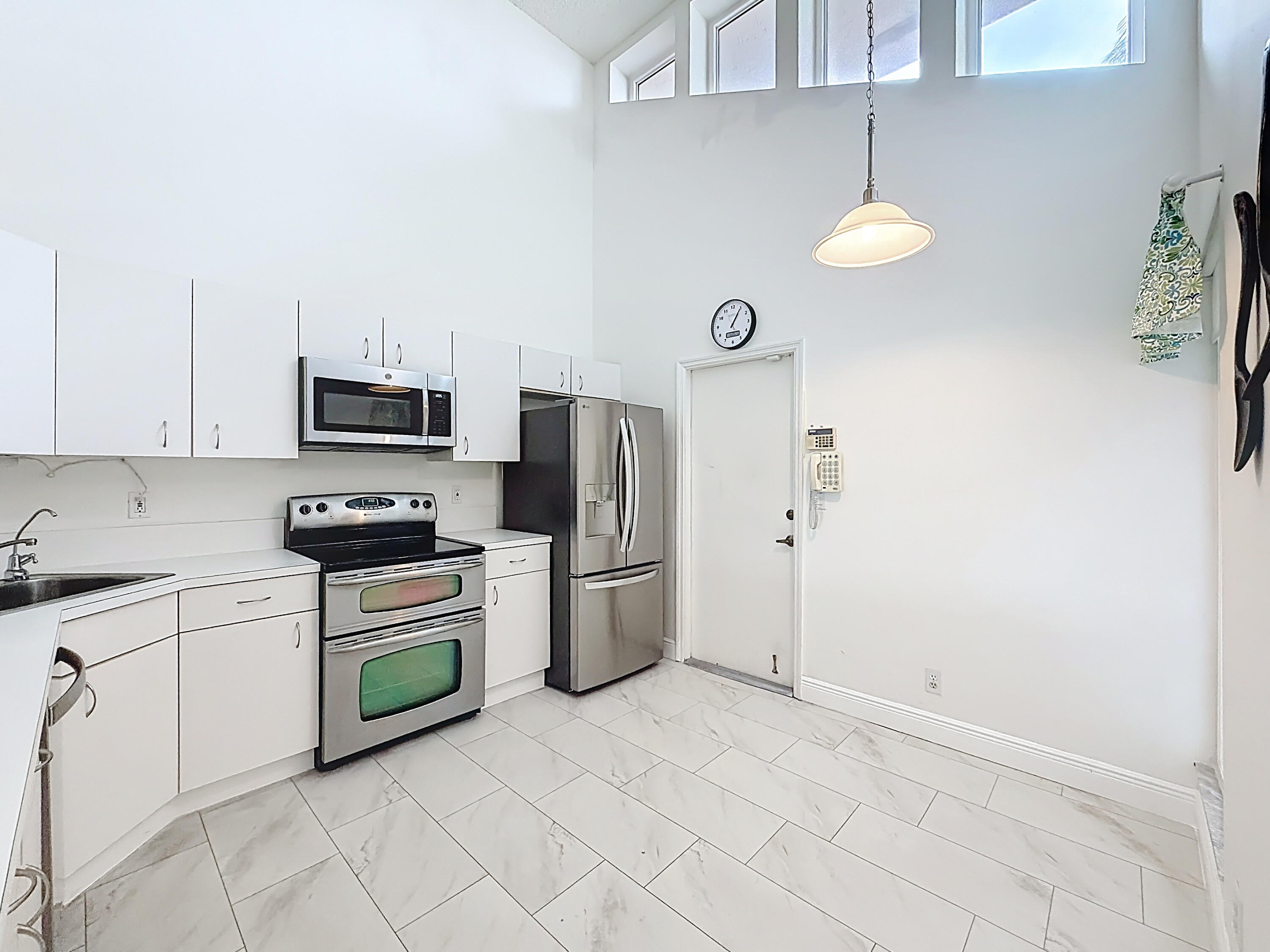 10954 Lakemore Lane Boca Raton, FL 33498 - Photo 9 of 61 a kitchen with a sink cabinets and stainless steel appliances