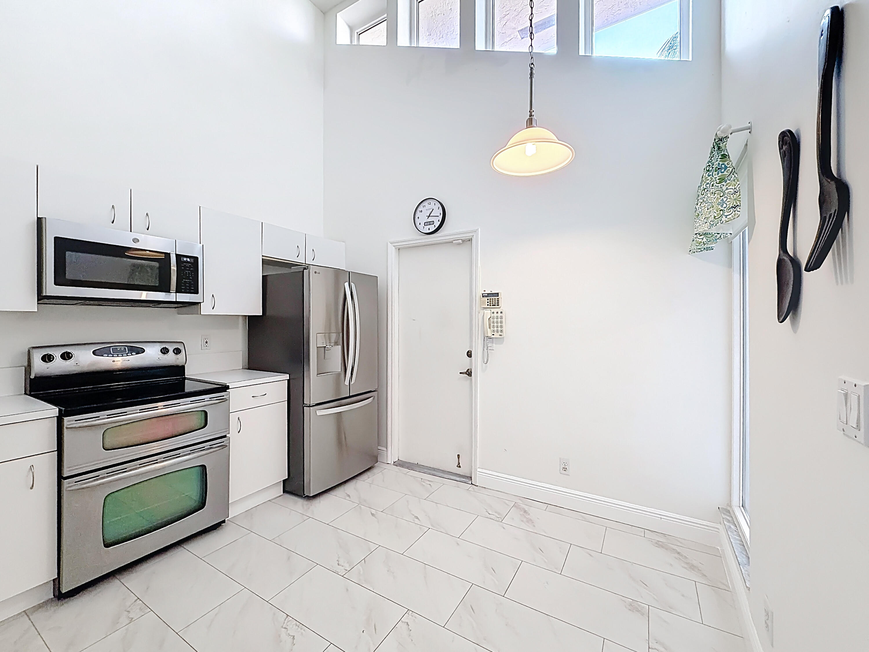 10954 Lakemore Lane Boca Raton, FL 33498 - Photo 10 of 61 a kitchen with a refrigerator a stove top oven a sink and dishwasher