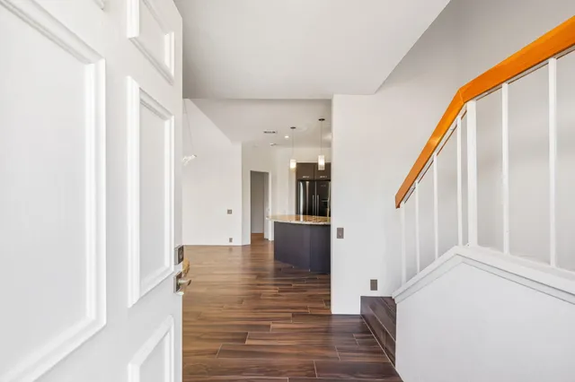 a view of an entryway with wooden floor and stairs