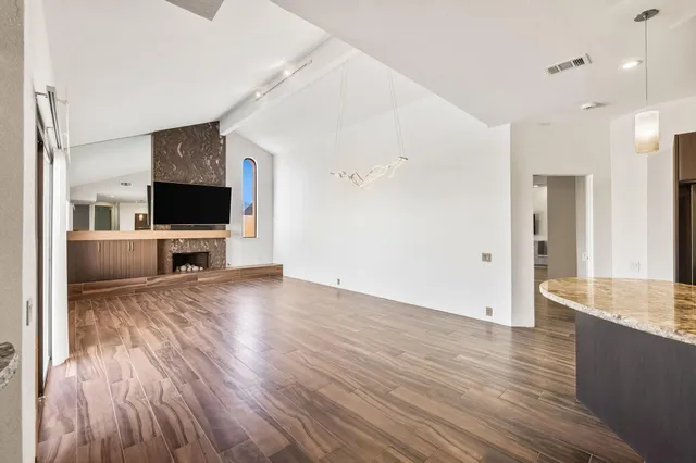 a kitchen with granite countertop cabinets stainless steel appliances and wooden cabinets