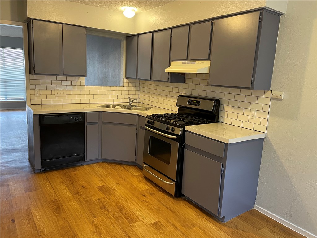 105 Meteor Drive, Unit A Austin, TX 78745 - Photo 1 of 23 a kitchen with stainless steel appliances granite countertop a stove a sink and a microwave