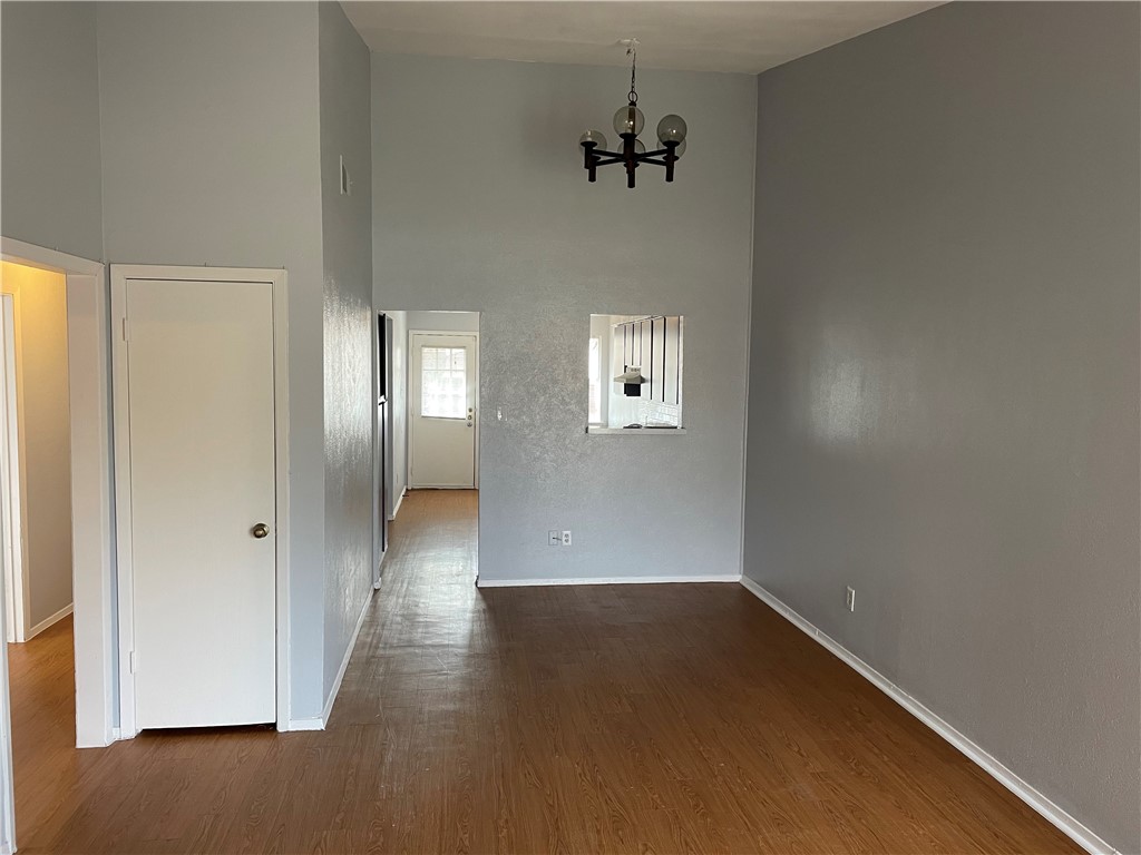 105 Meteor Drive, Unit A Austin, TX 78745 - Photo 11 of 23 an empty room with windows and cabinet